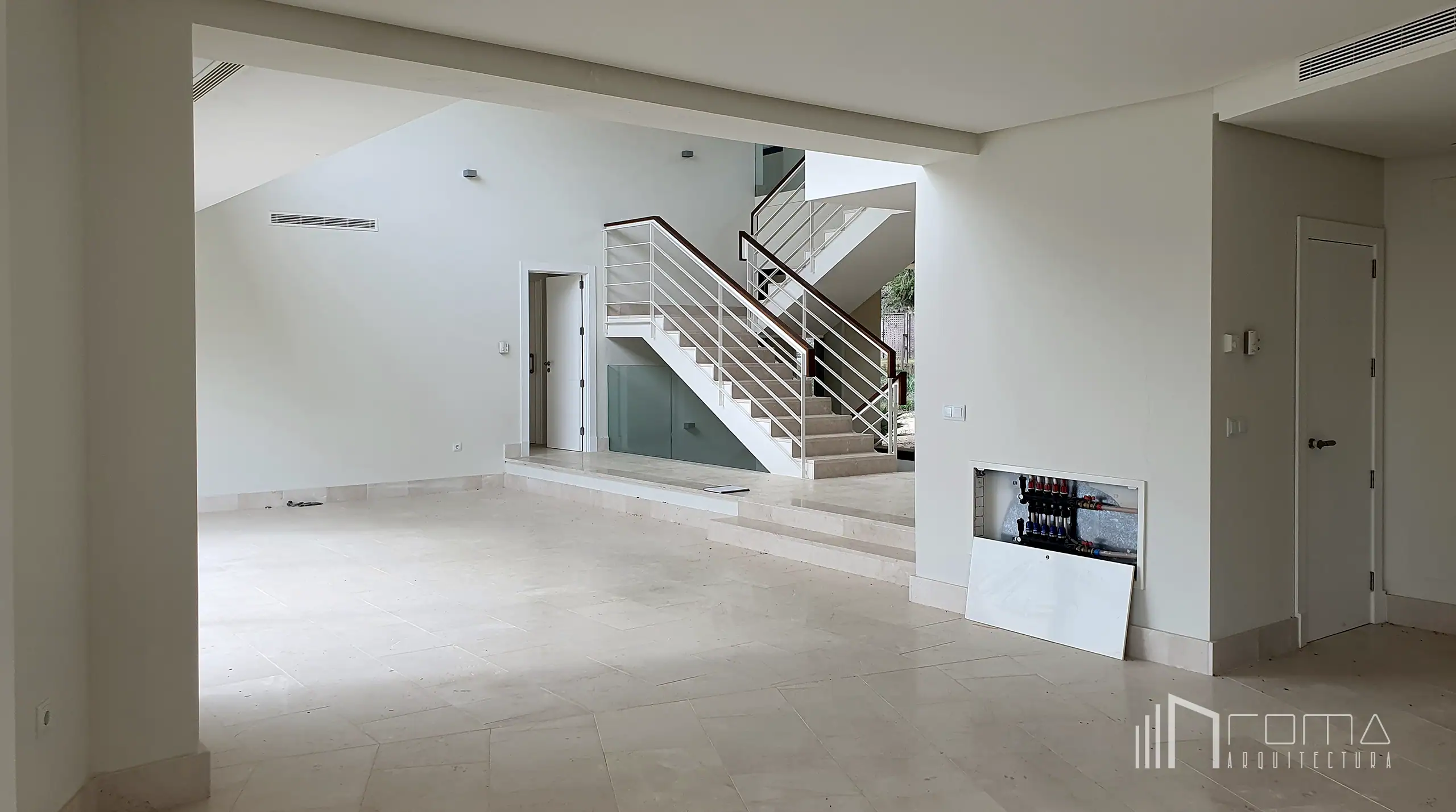 Interior design 1 Empty double-height living room and staircase prior to renovation in sotogrande, showcased within the interior design portfolio by roma arquitectura