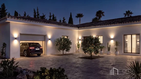 Paved courtyard with premium outdoor lighting, a modern garage, and landscaped orange trees at a villa entrance driveway, showcasing high-end sotogrande refurbishments by roma arquitectura studio, highly regarded architects.