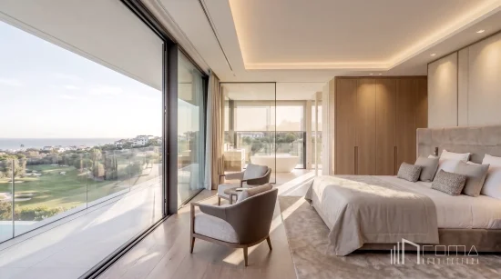 Master bedroom suite with glass-fronted balcony and open-concept en-suite bathroom, designed by roma arquitectura studio, renowned marbella luxury new builds architects.