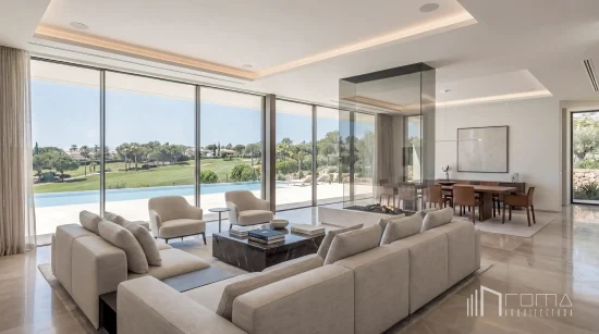 Double-height modern lounge with central glass fireplace, marble coffee table, and seamless terrace access, designed by roma arquitectura studio, leading sotogrande luxury new builds architects.